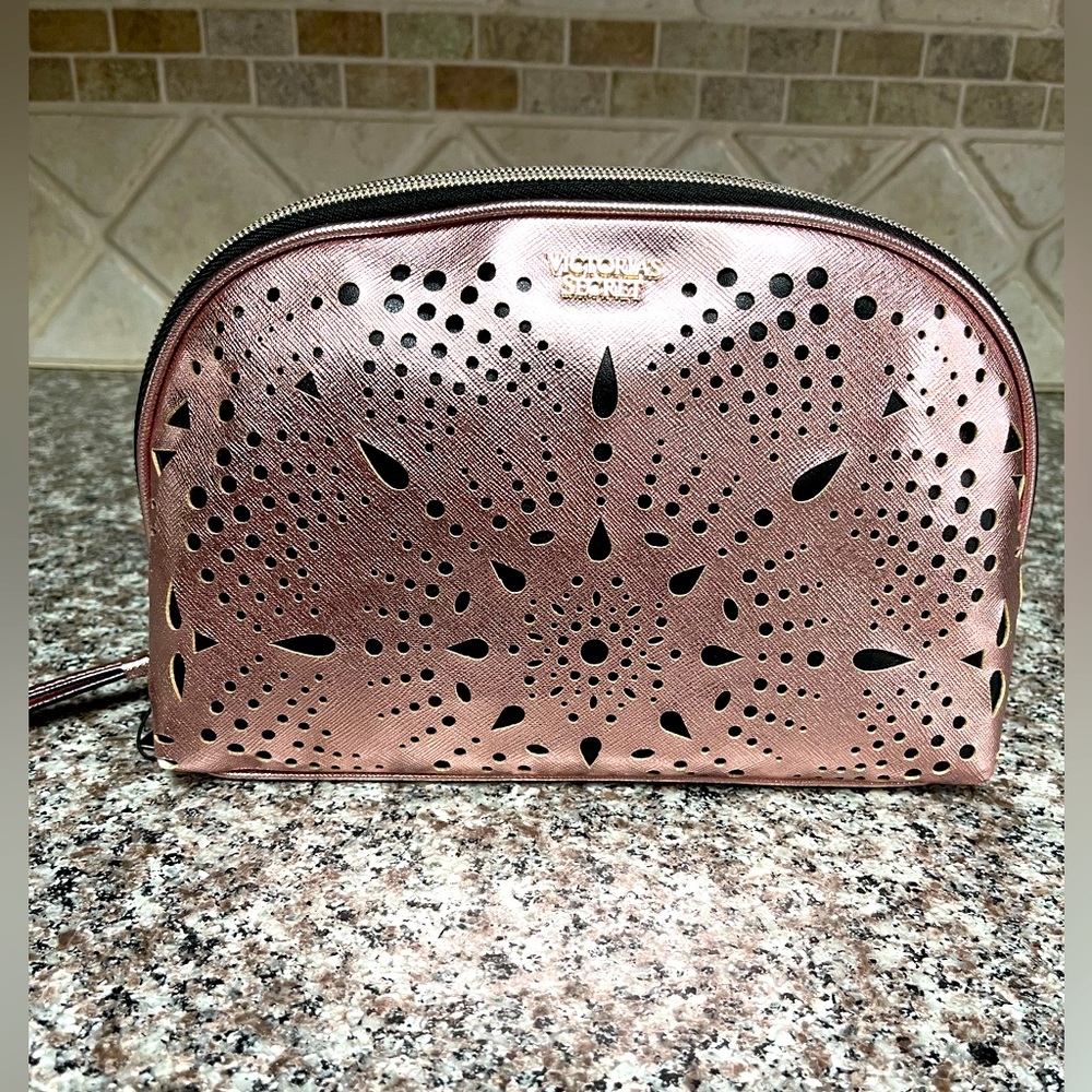 Brand new with tag VS cosmetic bag. Beautiful rose gold color with gold accent.